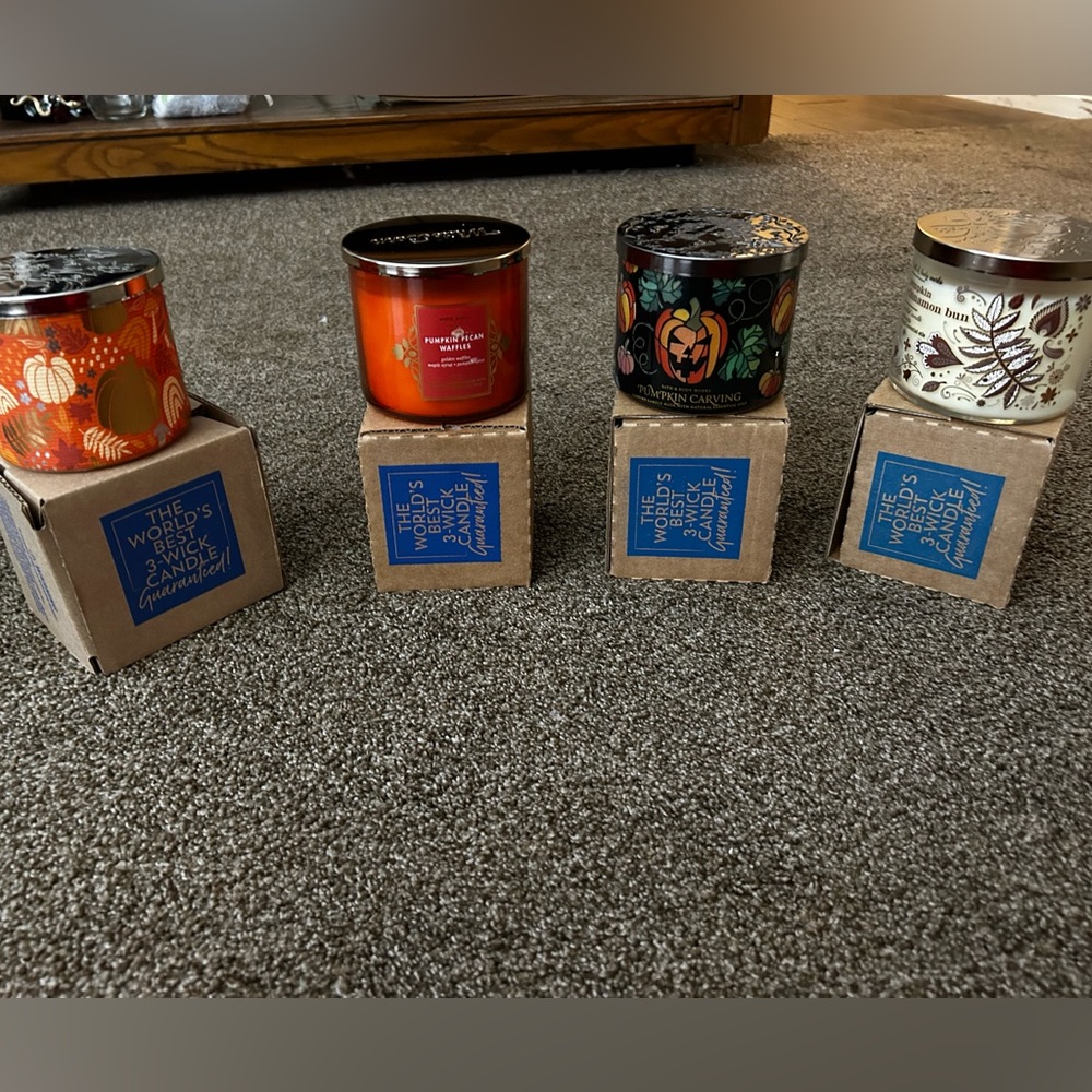 4 3 wick candles from Bath and Body Works.